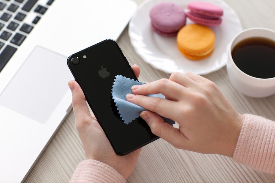 woman wiping the back of her iphone