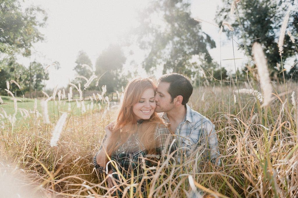 Couple sits in a field