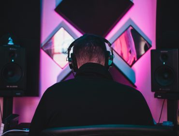 Man wearing black headphones discovers what is mastering in music production