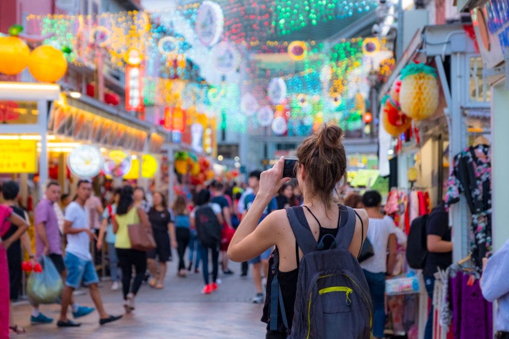 2019 March 1st, Singapore, Chinatown - People walking and shopping on the street market after sunset and taking street photography