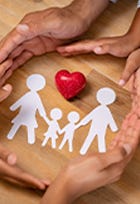hands around family paper cutout